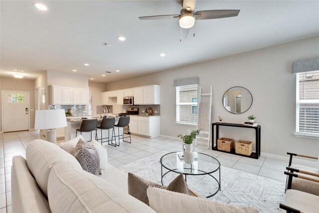 6608 May Shower Dr, Austin, TX 78744 - living room with recessed lighting, a ceiling fan, light tile patterned flooring, and baseboards