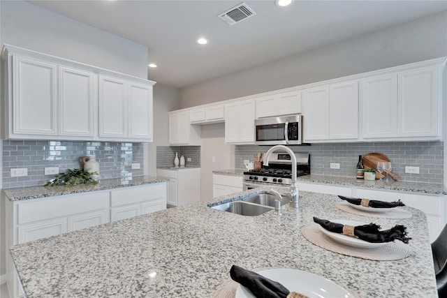 kitchen with white cabinetry, visible vents, and appliances with stainless steel finishes