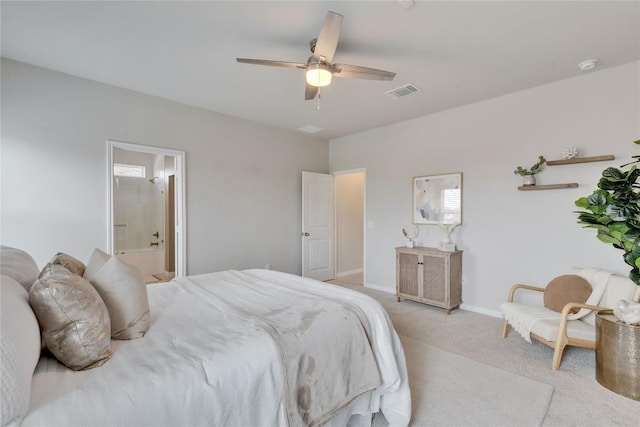bedroom featuring ensuite bathroom, visible vents, baseboards, a ceiling fan, and light carpet