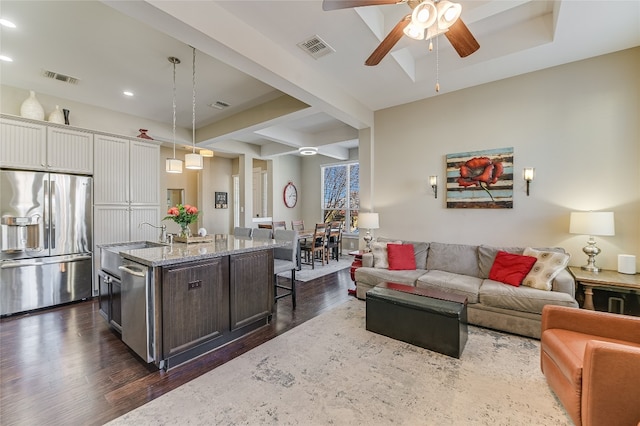 928 Sugaree Ave, Austin, TX 78757 - living room with a ceiling fan, dark wood finished floors, recessed lighting, and beamed ceiling