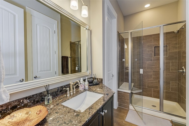 928 Sugaree Ave, Austin, TX 78757 - full bath with a shower stall, vanity, and wood finished floors