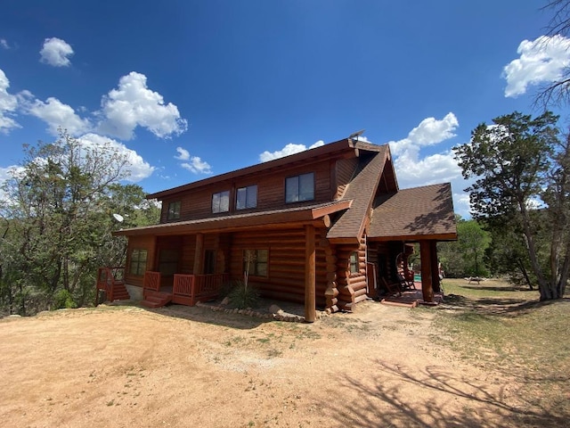 2550 Fm 2342 Hero'S Hideaway, Unit Heros Hideaway, Burnet, TX 78611 - view of front of property featuring log exterior, covered porch, and a shingled roof