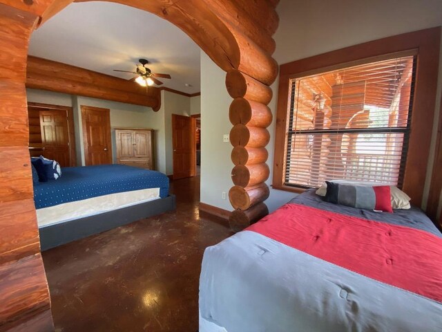 2550 Fm 2342 Hero'S Hideaway, Unit Heros Hideaway, Burnet, TX 78611 - bedroom featuring rustic walls, concrete flooring, and ceiling fan