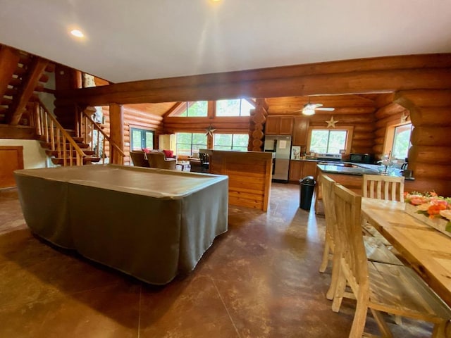 2550 Fm 2342 Hero'S Hideaway, Unit Heros Hideaway, Burnet, TX 78611 - kitchen with rustic walls, freestanding refrigerator, brown cabinets, plenty of natural light, and a peninsula