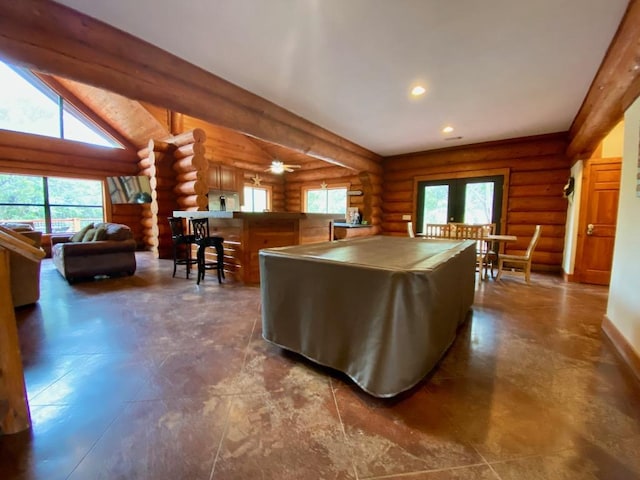 2550 Fm 2342 Hero'S Hideaway, Unit Heros Hideaway, Burnet, TX 78611 - kitchen featuring rustic walls, plenty of natural light, freestanding refrigerator, a kitchen breakfast bar, and ceiling fan