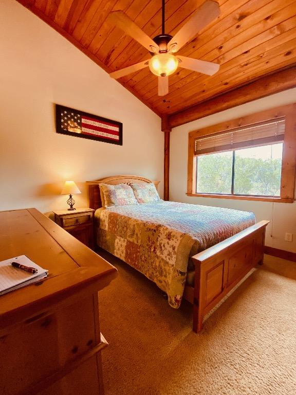 2550 Fm 2342 Hero'S Hideaway, Unit Heros Hideaway, Burnet, TX 78611 - bedroom with wooden ceiling, lofted ceiling, light colored carpet, and a ceiling fan