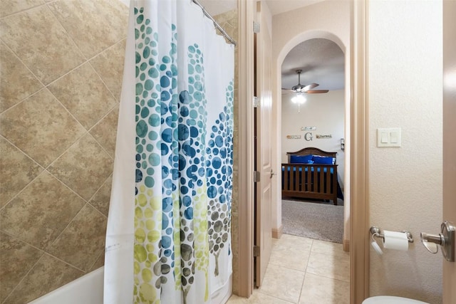 ensuite bathroom with ensuite bath, shower / bathtub combination with curtain, tile patterned floors, and a ceiling fan