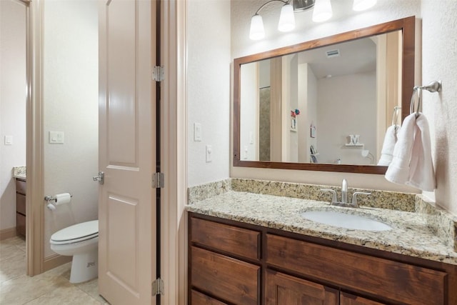bathroom featuring visible vents, tile patterned floors, toilet, and vanity
