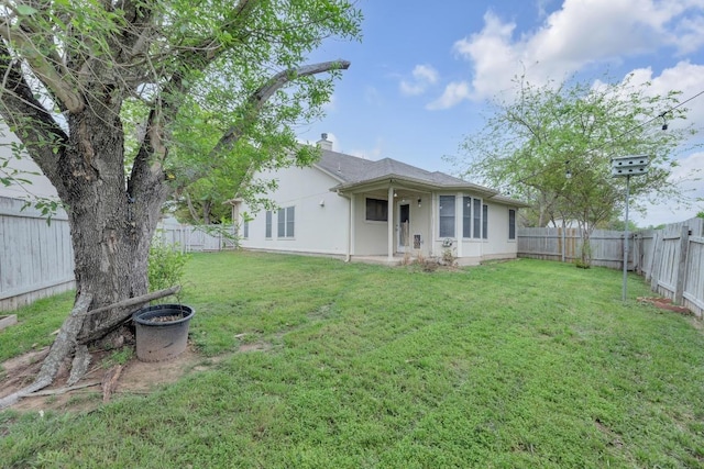 1708 Royal Ascot Dr, Pflugerville, TX 78660 - rear view of property featuring a lawn, a chimney, a fenced backyard, and stucco siding