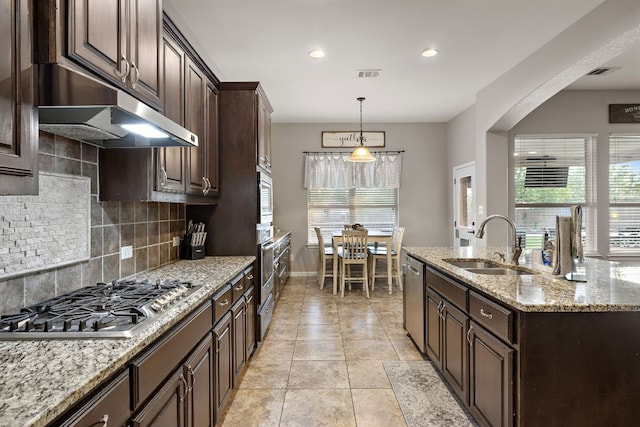 kitchen featuring dark brown cabinets, a sink, stainless steel appliances, and visible vents
