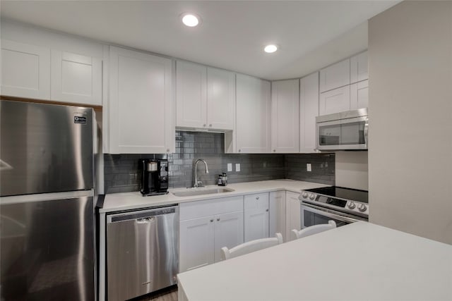 kitchen with light countertops, a sink, and appliances with stainless steel finishes