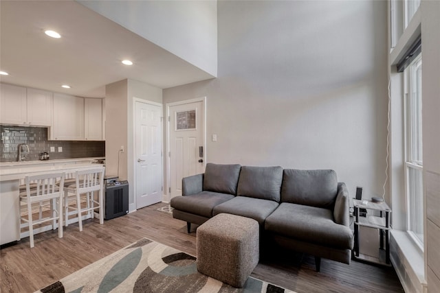 living area with recessed lighting and light wood-style floors