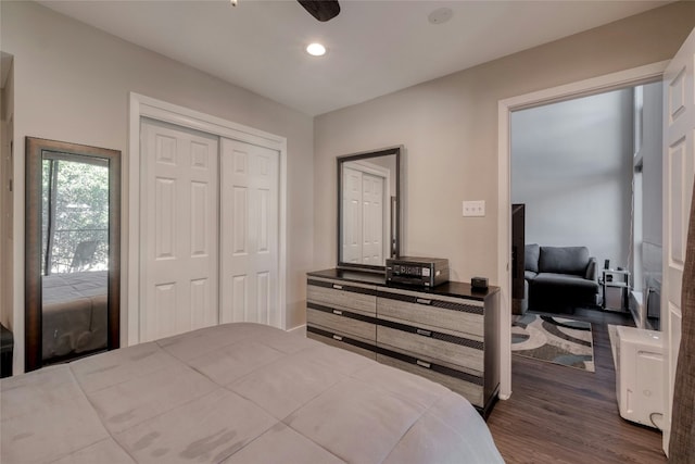 bedroom with dark wood-type flooring, a closet, and recessed lighting