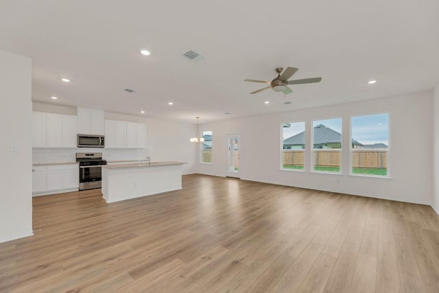 4915 Mozzafiato Ln, Round Rock, TX 78665 - unfurnished living room with light wood-style flooring, recessed lighting, and ceiling fan