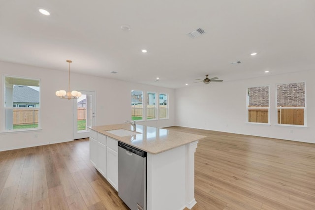 4915 Mozzafiato Ln, Round Rock, TX 78665 - kitchen featuring stainless steel dishwasher, ceiling fan, light wood-style flooring, white cabinets, and open floor plan