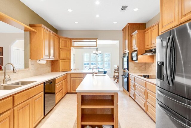 kitchen with a sink, visible vents, black appliances, and open shelves