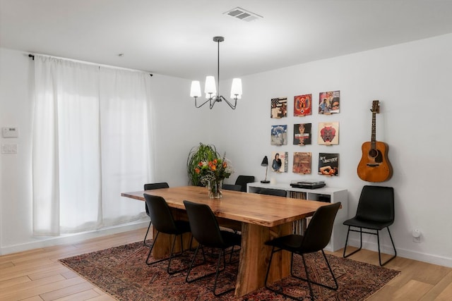 10100 Dobbin Dr, Austin, TX 78748 - dining room with a chandelier, light wood-style floors, and baseboards