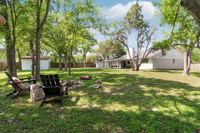 10100 Dobbin Dr, Austin, TX 78748 - view of yard featuring a fire pit and an outdoor structure