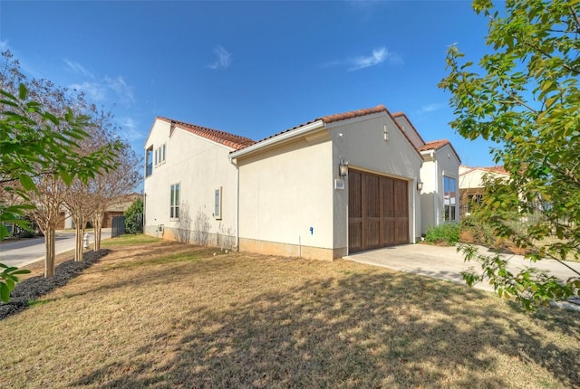 12113 Beautybrush Dr, Austin, TX 78738 - view of property exterior with an attached garage, a tiled roof, stucco siding, concrete driveway, and a yard