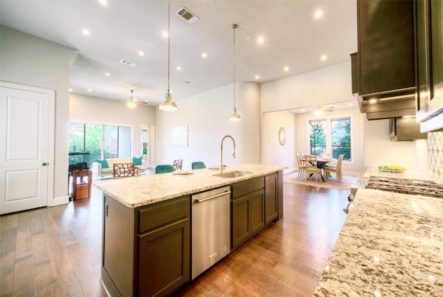 12113 Beautybrush Dr, Austin, TX 78738 - kitchen featuring stainless steel dishwasher, a ceiling fan, wood finished floors, light stone counters, and recessed lighting