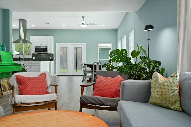living room featuring ceiling fan, french doors, recessed lighting, and wood finished floors