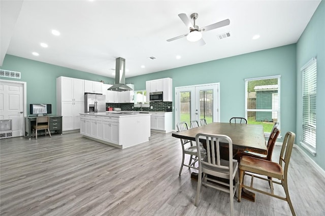 dining room with a wealth of natural light, french doors, and visible vents
