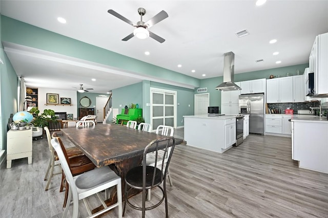 dining space with visible vents, stairway, recessed lighting, a ceiling fan, and light wood finished floors