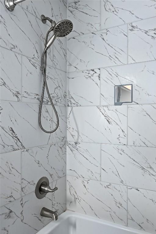 room details featuring bathtub / shower combination