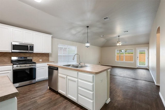 4009 Veiled Falls Dr, Pflugerville, TX 78660 - kitchen with stainless steel appliances, dark wood-style flooring, decorative backsplash, light countertops, and lofted ceiling