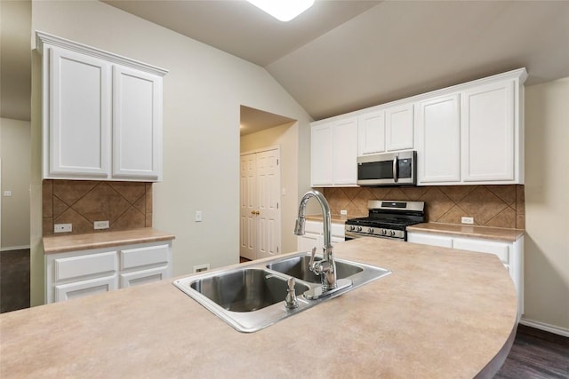 4009 Veiled Falls Dr, Pflugerville, TX 78660 - kitchen with stainless steel appliances, white cabinetry, decorative backsplash, light countertops, and vaulted ceiling