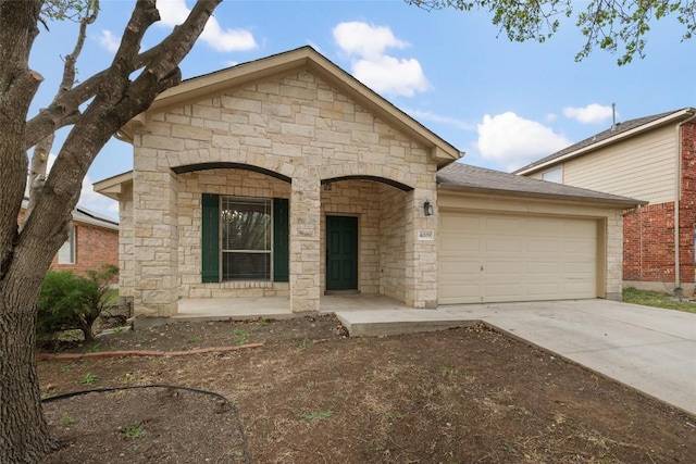 4009 Veiled Falls Dr, Pflugerville, TX 78660 - view of front of property with stone siding, a garage, and concrete driveway