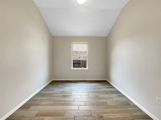 137 Periwinkle Ln, Bastrop, TX 78602 - empty room with wood finished floors and lofted ceiling