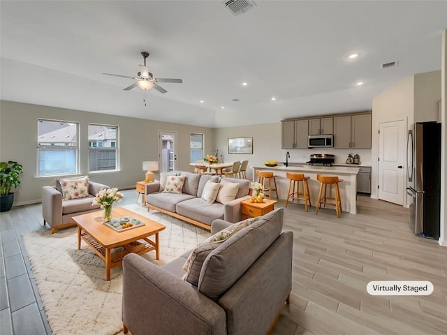 137 Periwinkle Ln, Bastrop, TX 78602 - living area featuring light wood finished floors, ceiling fan, and recessed lighting