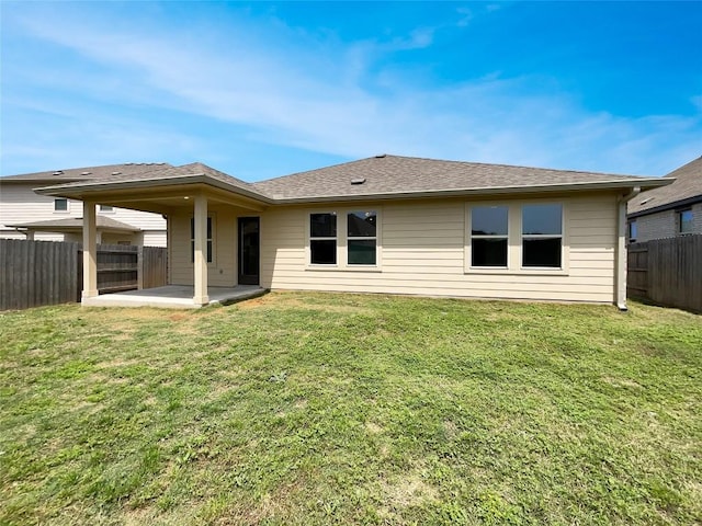 137 Periwinkle Ln, Bastrop, TX 78602 - back of property with a patio area, a fenced backyard, and roof with shingles