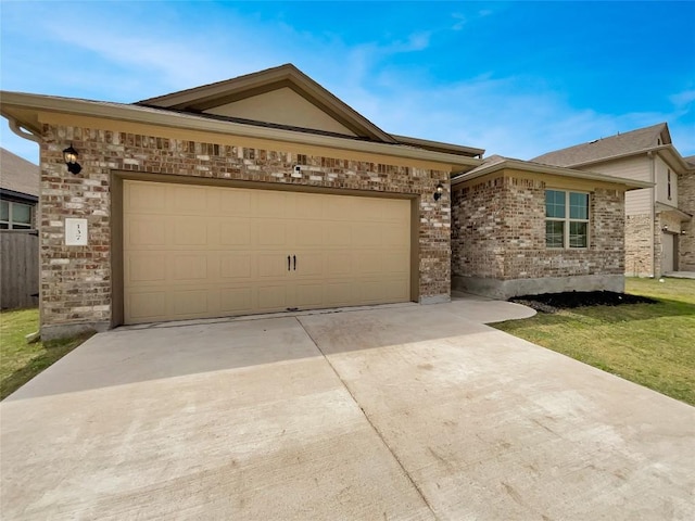 137 Periwinkle Ln, Bastrop, TX 78602 - single story home featuring concrete driveway, brick siding, and a garage