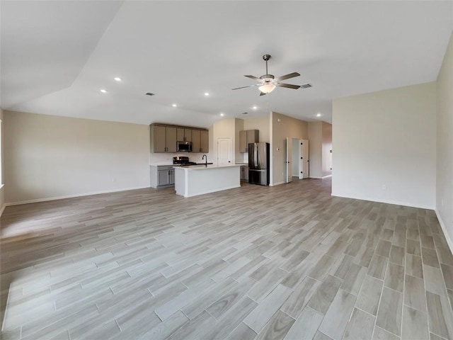 137 Periwinkle Ln, Bastrop, TX 78602 - unfurnished living room featuring a ceiling fan, recessed lighting, and light wood-style floors