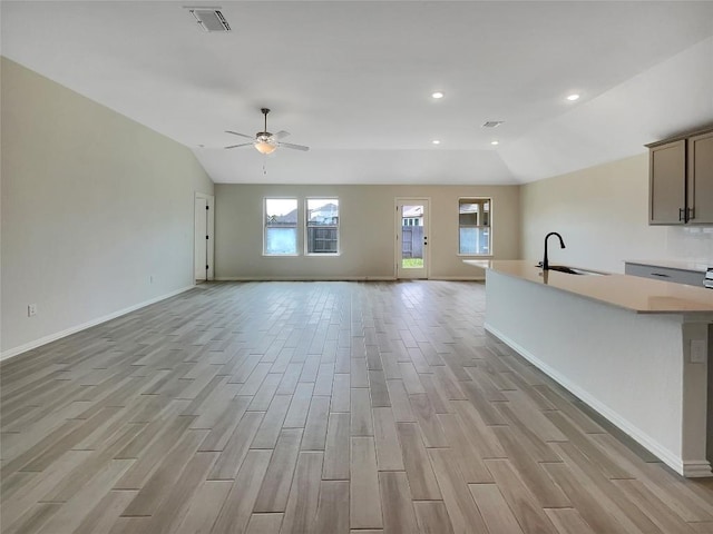 137 Periwinkle Ln, Bastrop, TX 78602 - unfurnished living room with light wood-type flooring, lofted ceiling, a ceiling fan, and recessed lighting