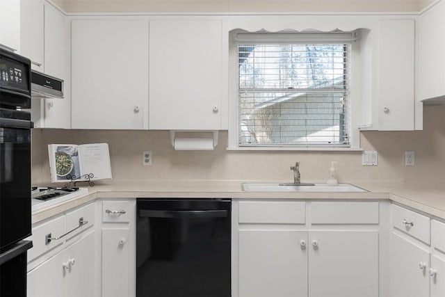 kitchen featuring white cabinetry, black appliances, light countertops, and a sink