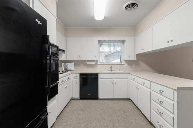 kitchen featuring visible vents, black appliances, light countertops, and a sink