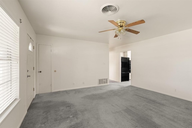 unfurnished room featuring ceiling fan, visible vents, and plenty of natural light