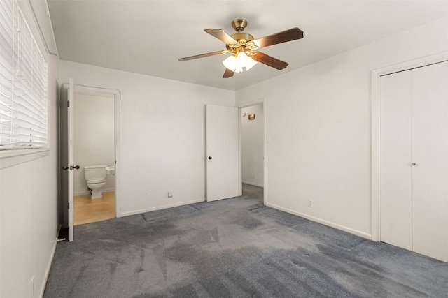 unfurnished bedroom with connected bathroom, baseboards, ceiling fan, and carpet flooring