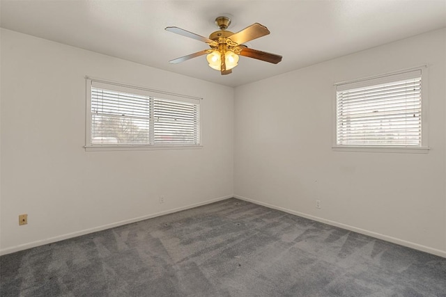 carpeted empty room with baseboards, a wealth of natural light, and ceiling fan