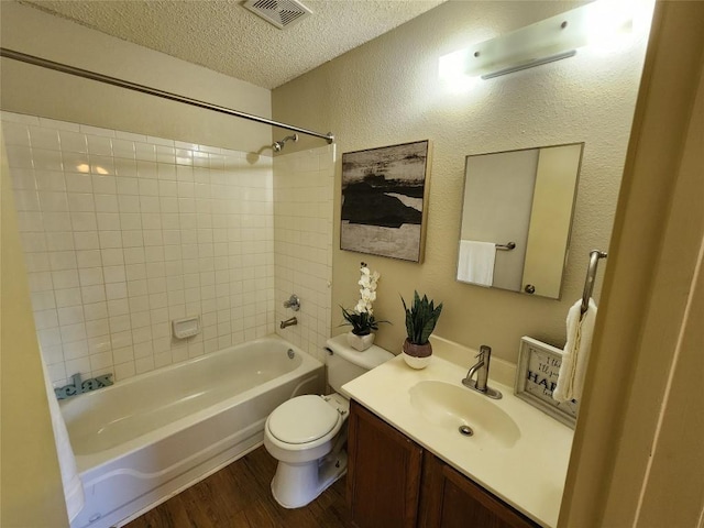 2516 Glen Field Dr, Cedar Park, TX 78613 - bathroom featuring shower / tub combination, vanity, wood finished floors, and a textured ceiling