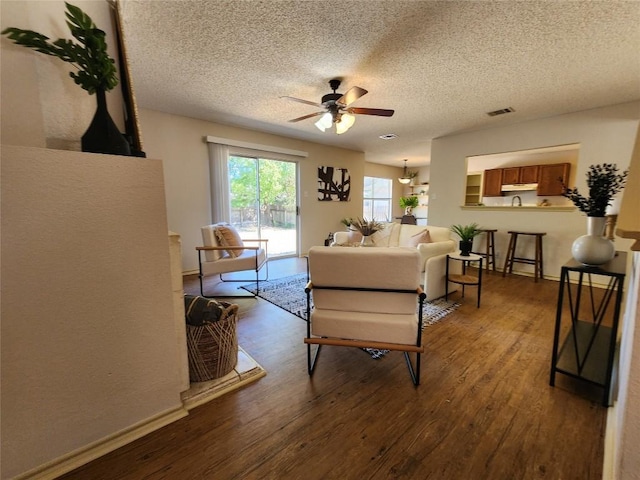 2516 Glen Field Dr, Cedar Park, TX 78613 - living room with a ceiling fan, dark wood-style flooring, and a textured ceiling