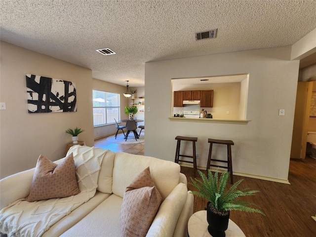 2516 Glen Field Dr, Cedar Park, TX 78613 - living area featuring wood finished floors and a textured ceiling