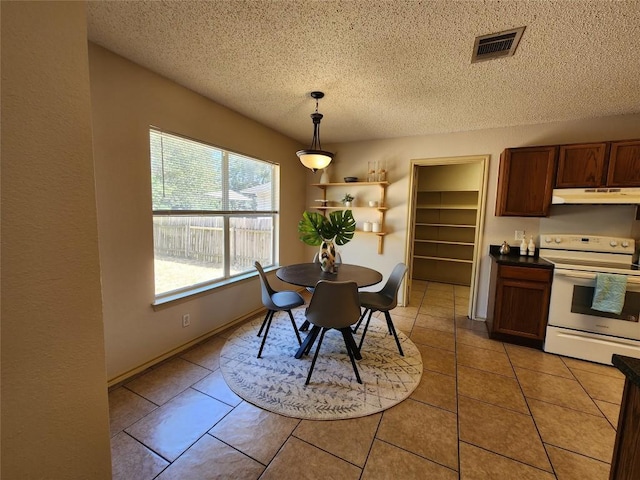 2516 Glen Field Dr, Cedar Park, TX 78613 - dining room featuring a textured ceiling and light tile patterned flooring