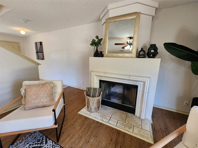2516 Glen Field Dr, Cedar Park, TX 78613 - living room with wood finished floors, a textured ceiling, a fireplace, and a ceiling fan