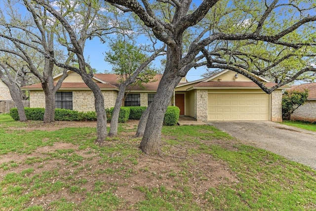1306 Daytona Dr, Austin, TX 78733 - view of front of house featuring driveway, a garage, and stone siding