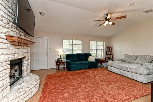 1306 Daytona Dr, Austin, TX 78733 - living room with a ceiling fan, vaulted ceiling, wood finished floors, and a fireplace