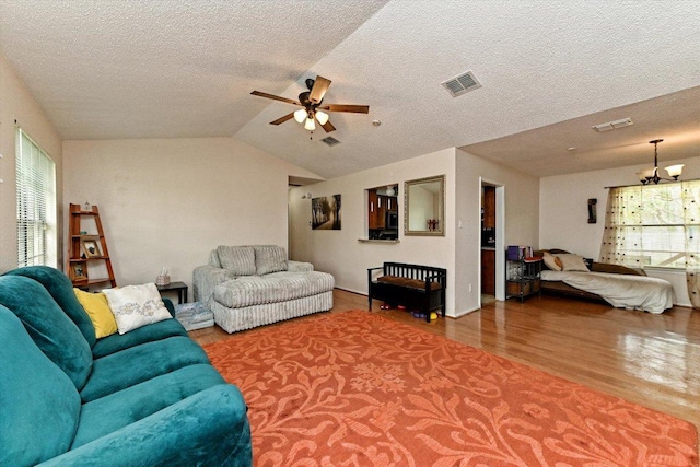 1306 Daytona Dr, Austin, TX 78733 - living room with wood finished floors, ceiling fan, plenty of natural light, a textured ceiling, and lofted ceiling